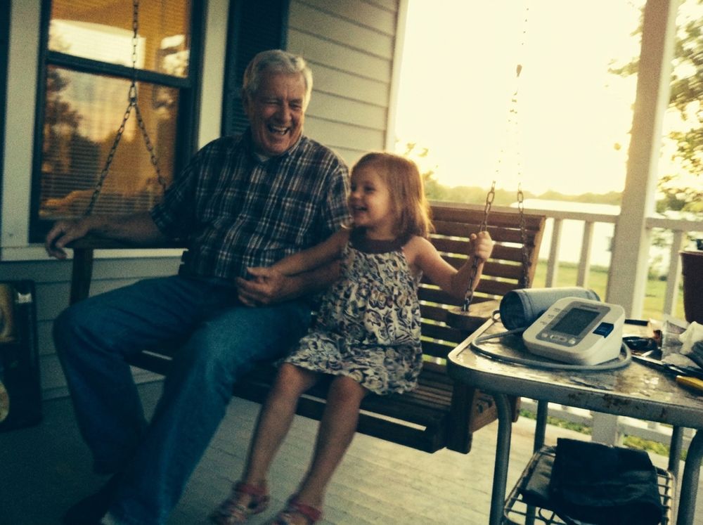 Frank on the porch with his granddaughter