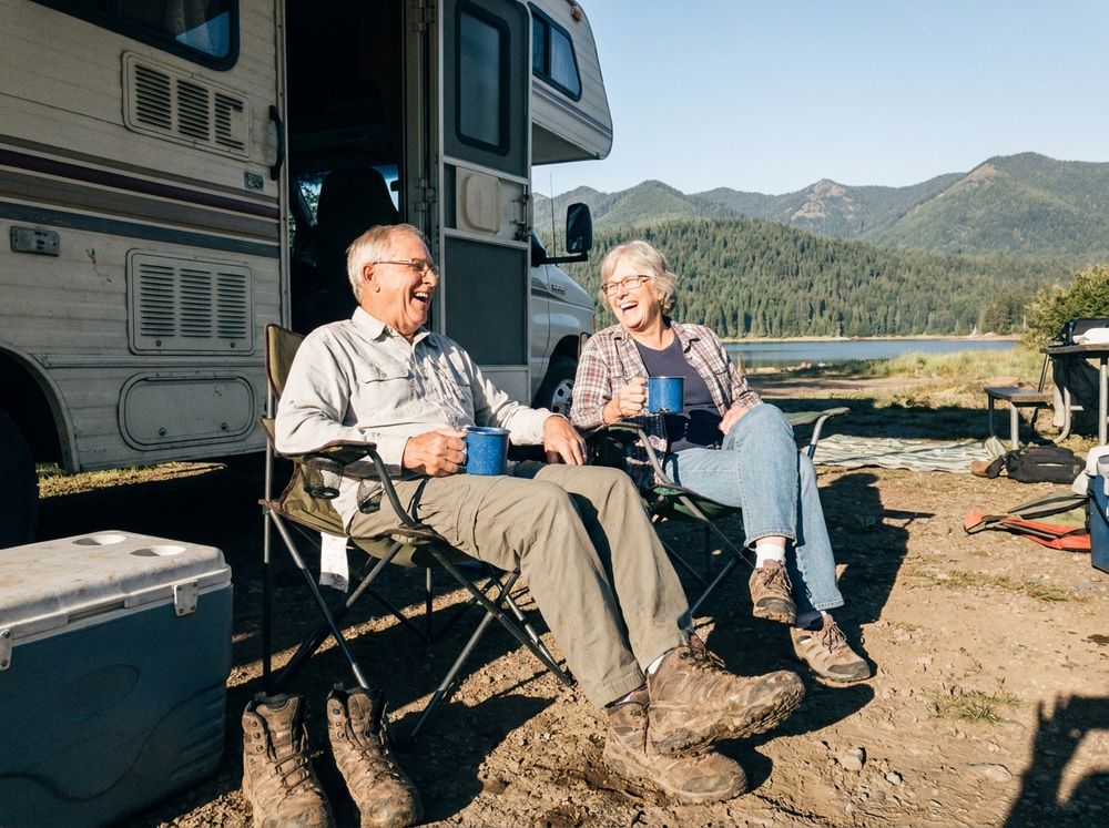 Walt and June with morning coffee beside the RV